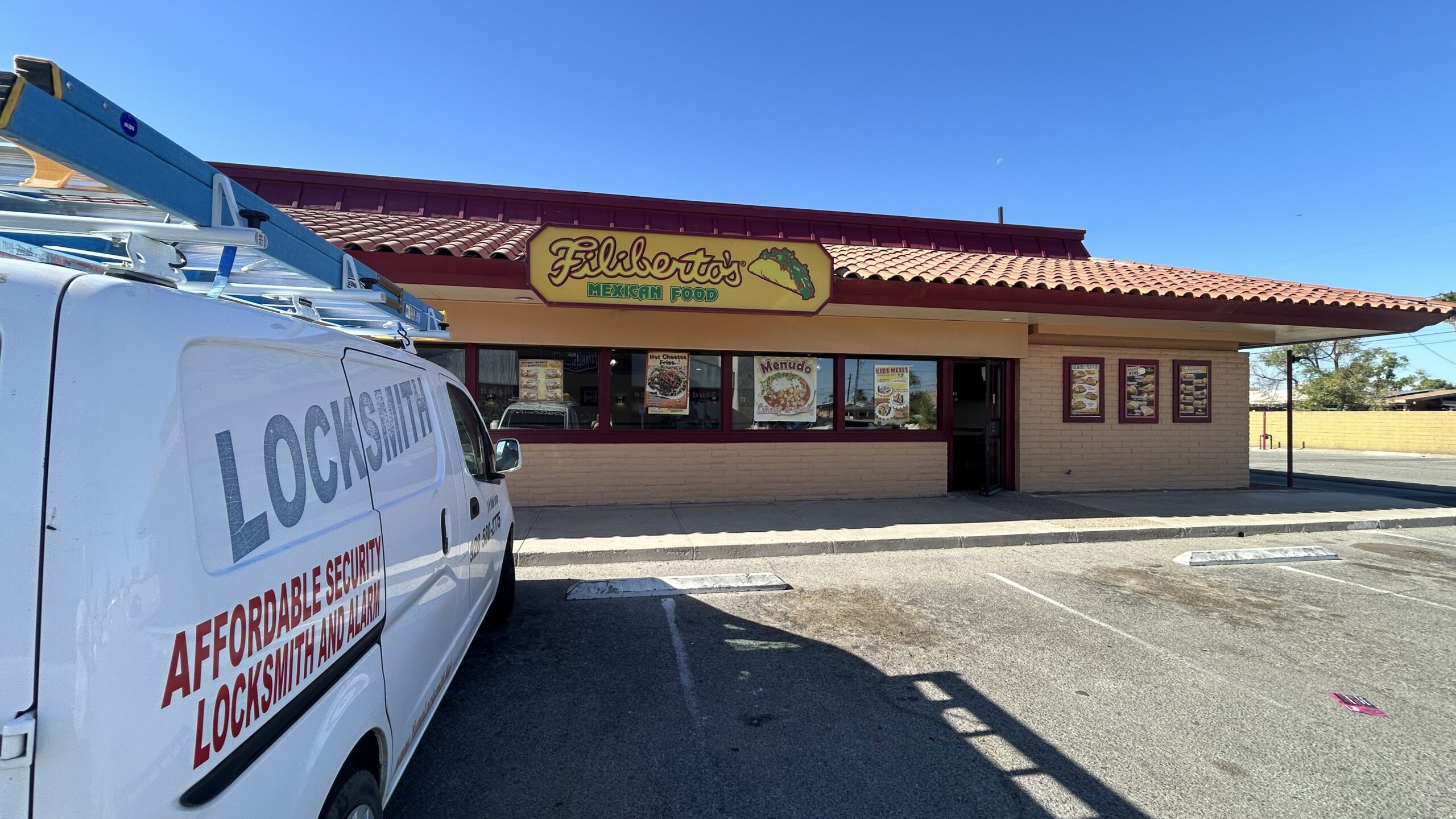 Affordable Security Van installing a lock at Filiberto's mexican in Phoenix Affordable Security Van installing a lock at Filiberto's mexican in Phoenix